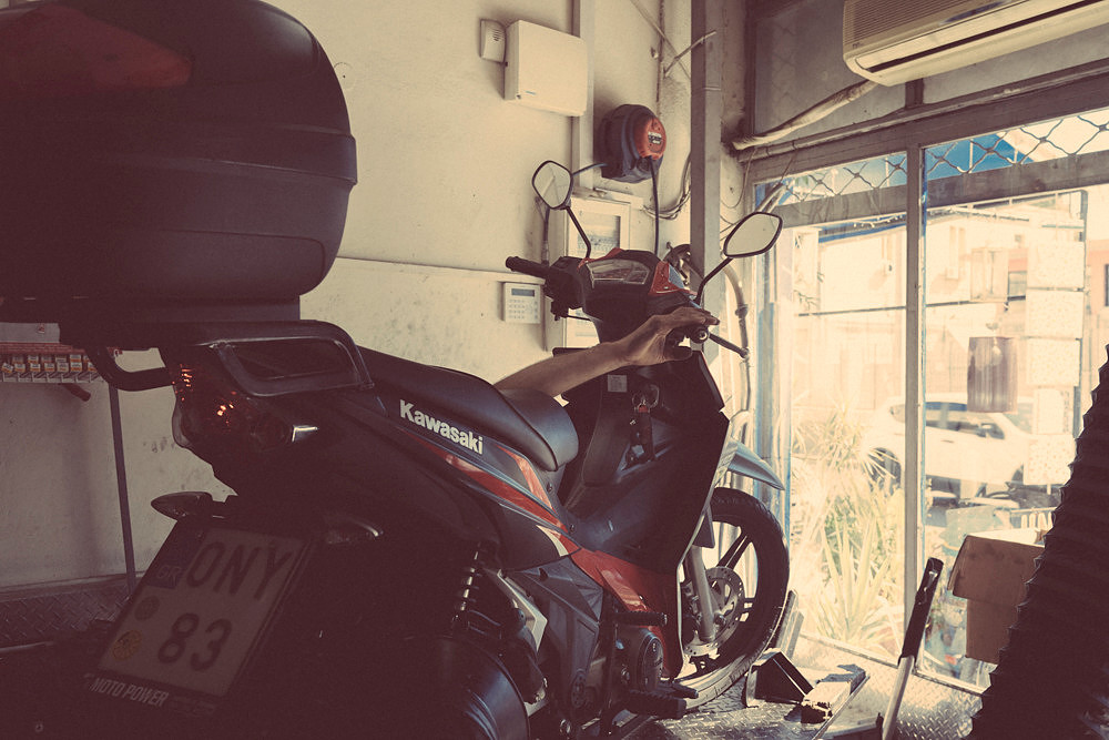 "bike shop", Pireas, "reluctant model", colours,  "nescafé cans", tools, "motor bikes"